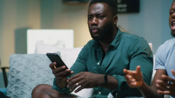 African American fans making bets on smartphones — Stock Photo, Image