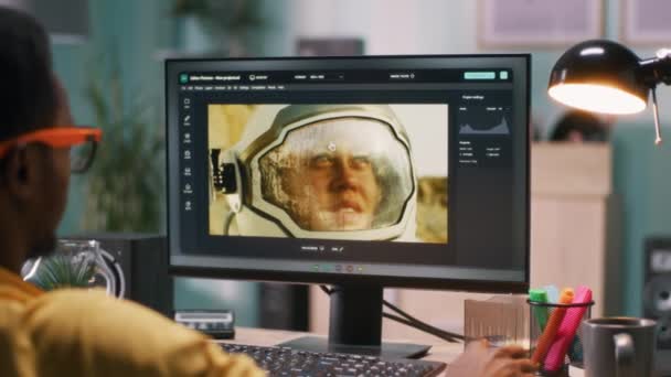 African American guy retouching photo of cosmonaut — Stock Video