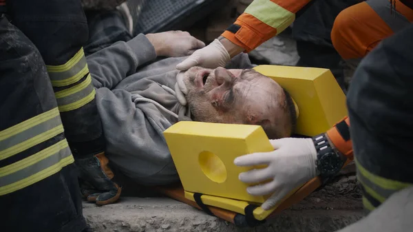 災害後に負傷した男性を運ぶ救急車 — ストック写真