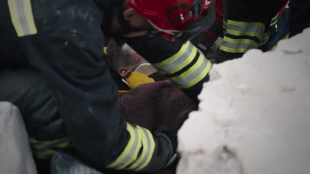 Male rescuers saving teenager from concrete blocks — Stock Video