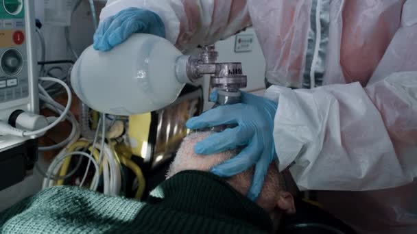 Crop paramedic helping senior patient to breath — Video Stock