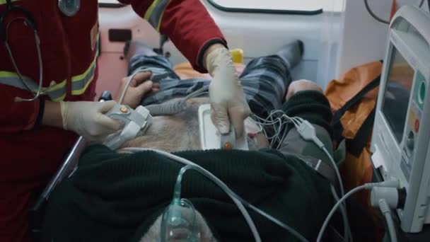 Crop paramedic trying to reanimate elderly man — Vídeo de Stock