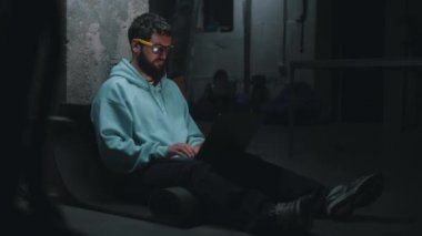 Programmer working in dark bomb shelter