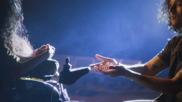 During a rehearsal of a romantic performance with a director, an actor on his knees singing a song to a disabled actress on a stage illuminated by a spotlight