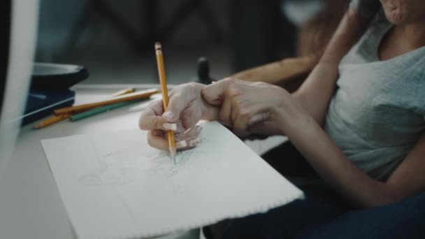 Woman Disability Wheelchair Sitting Desk Drawing Sketch Pencil Sheet Paper — 图库视频影像