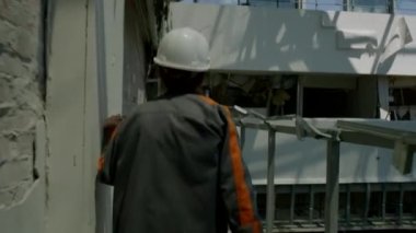 ZAPORIZHIA, UKRAINE - JULY 19, 2022: an engineer shows the destruction of the Aurora building after being hit by a Russian missile during the war and Russian aggression in Ukraine