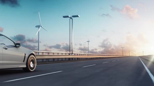 一般的な電気自動車の3Dレンダリングは 日没時に風力タービンを背景に高速道路で駆動します 現実的な3Dアニメーション — ストック動画