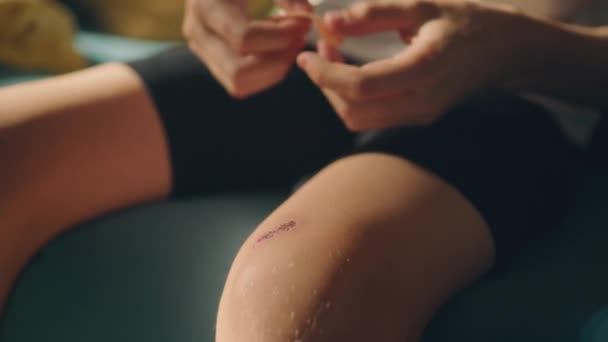 Teenage Boy Applying Medical Adhesive Plaster His Knee First Aid — Stock Video