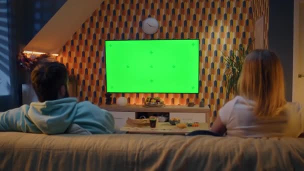 거실의 소파에 시리즈의 스낵을 시청하는 부부들이 아내와 남편은 집에서 쉬면서 — 비디오
