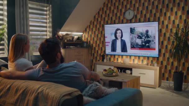 Couple Sitting Sofa Living Room Together Talking Watching News Disaster — Stock Video