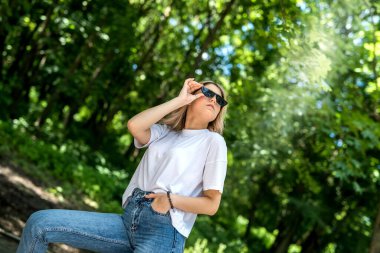 Ormanda yürüyen ve temiz hava soluyan bir kadın yazın boş zamanlarının tadını çıkarır. 