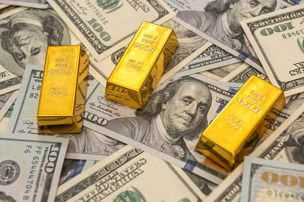 large bank gold bars bullions on dollars bills. saving concept
