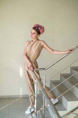 Binanın içindeki merdivenlerde poz veren genç bayan.