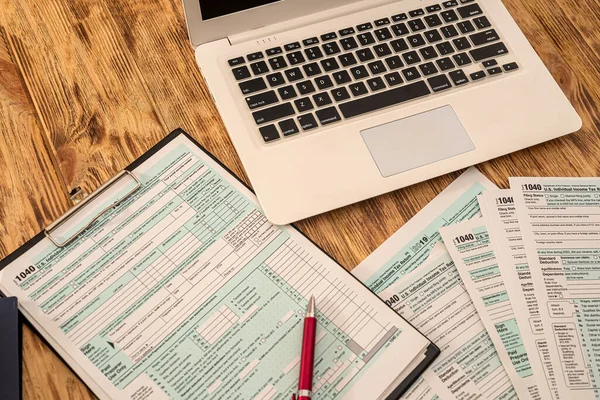 Wooden Table Laptop Calculator Dollar Bills Pen Tax Forms Business — Stockfoto