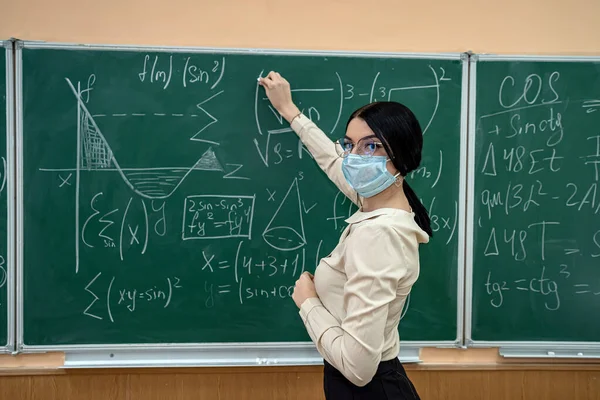 마스크를 교사는 코로나 바이러스가 유행하는 학교에서 수학을 배웠습니다 사회적 — 스톡 사진