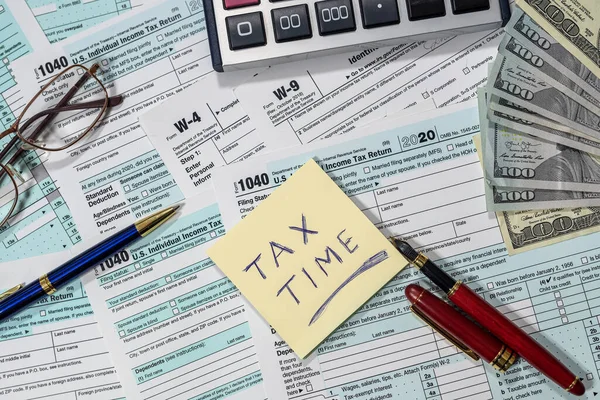1040号税单 用美元 钢笔和计算器填写在一张漂亮木头做的桌子上 税收时间的概念 财务文件 — 图库照片