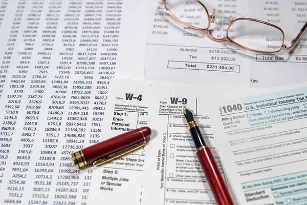 many us tax form 1040 w4 w9 on office desk. financial documents. Financial concept. Tax time.