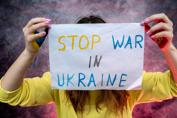 female hands holding poster anti war symbol in Ukraine. save people's lives. russia international terrorist