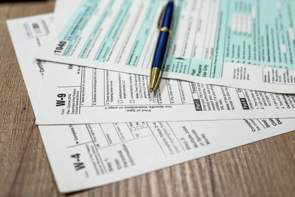 many us tax form 1040 w4 w9 on office desk. financial documents. Financial concept. Tax time.