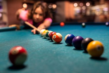 Güzel bir kadın barda bilardo oynayarak boş zaman geçirir. oyun konsepti