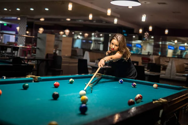 Happy caucasian woman wear casual cloth playing a game of billiards, lifestyle