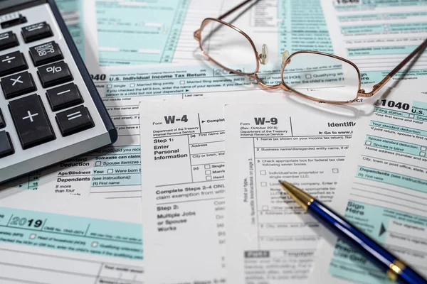 return U.S tax forms 1040 with pen calculator and glasses,  business financial concept. Financial concept. Tax time.