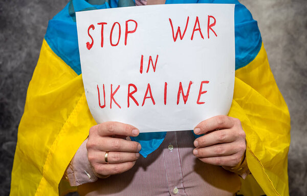 man hold poster with text stop no war in Ukraine. protest around the world for the Santians against the terrorist state of Russia