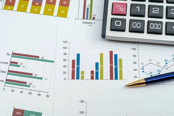 Annual financial document data charts with calculator pen on desk.  financial accounting concept