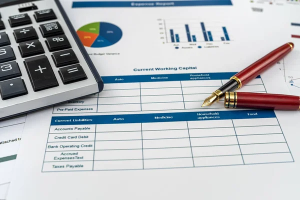 Annual financial document data charts with calculator pen on desk.  financial accounting concept