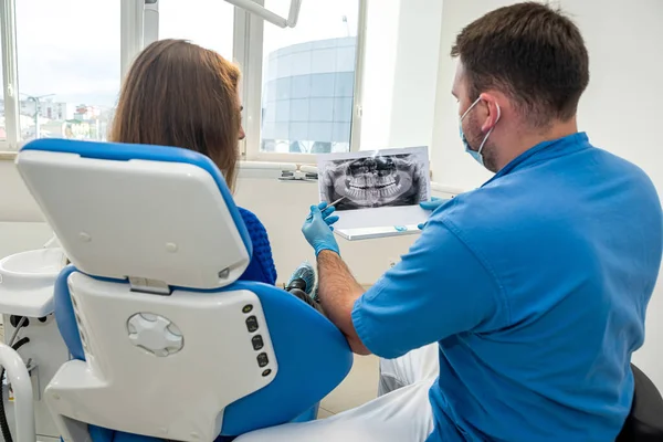 in professional dentistry, a dentist who knows his business takes pictures for a patient with diseased teeth. The concept of pictures of teeth in patients