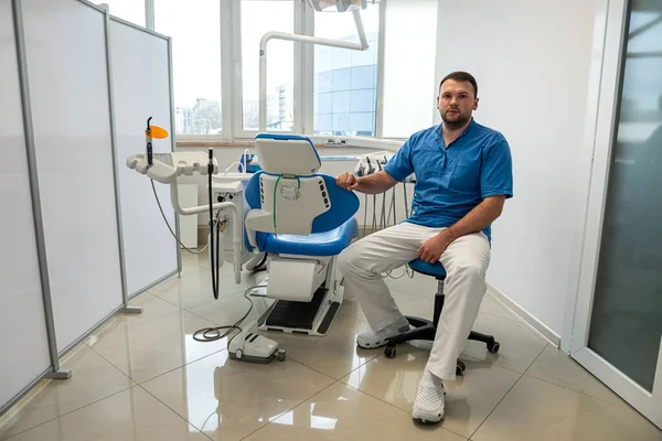 in the professional dentistry of the city, a good male dentist treats all patients\' teeth. Dentist professional concept