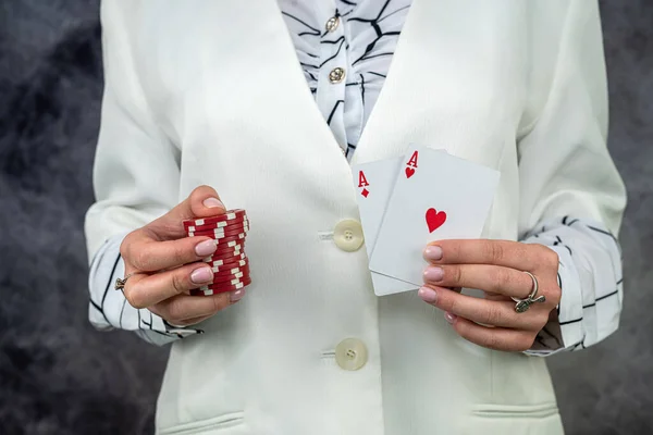 woman in casino shows 2 aces as a winning combination, winning in a casino, a lot of money