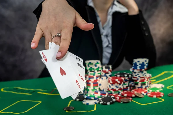 woman wear suit holding chips in casino, gambling concept