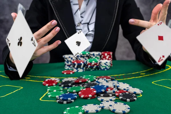 woman wear suit holding chips in casino, gambling concept