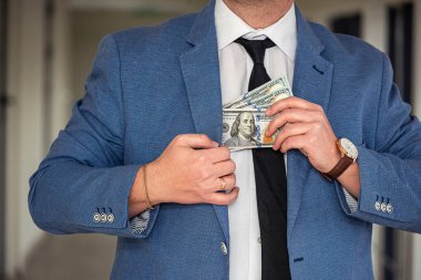 an outstanding man with beautiful strong hands has to hand over a large sum of dollars to the workers. Big and small business concept
