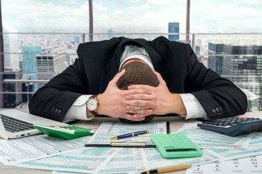 businessman in black suit cannot fill out a tax form and needs help