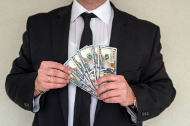 handsome stylish businessman in trade owns many thousands of dollars. The concept of big profitable business