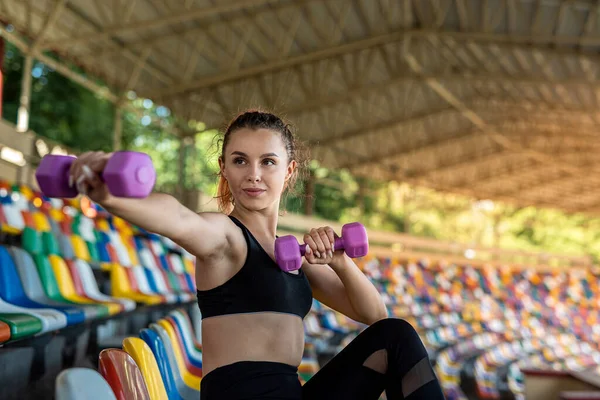 Female Trainer Doing Exercises Dumbbells Stadium Chairs Active Lifestyle — стоковое фото