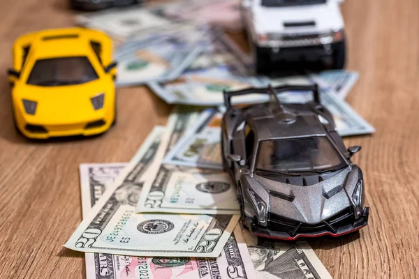 Children\'s car with dollars on the table