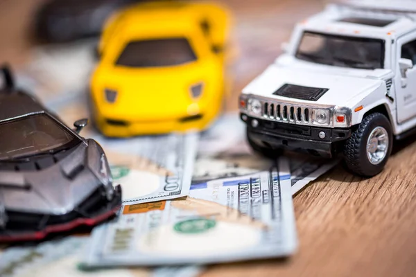 Children\'s car with dollars on the table