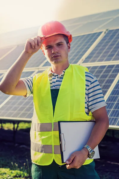 engineer in uniform working of solar power plant. Solar station development concept