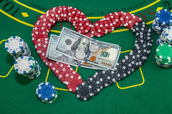 many colored chips of cards and dollars are scattered for poker. Love to play poker