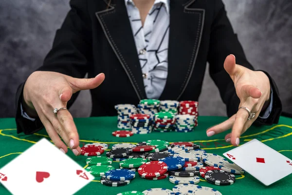 young woman wear black suit playing poker in casino. winner