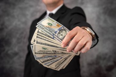 a large-scale entrepreneur calculates a salary in dollars and distributes it to workers. Salary concept in dollars