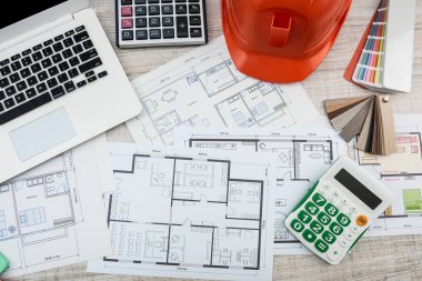Top view of a drawing of the architects of a modern house with a sample of material on a creative table. Design concept