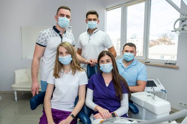 Tıpta deneyimli, portre için poz vermeyi seven genç ve güzel insanlar. Portredeki mutlu dişçi kavramı