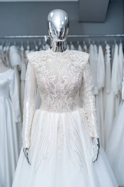 Beautiful white wedding dress on mannequin in trendy bridal show room