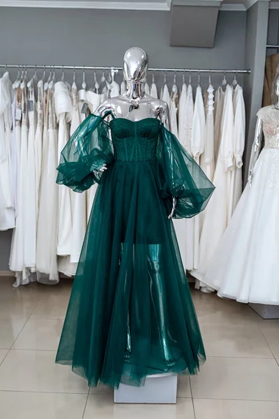 Luxurious green evening dress in store. High fashion concept