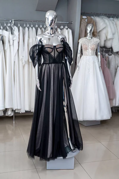 Elegant black evening dresses on the mannequin in showroom. Fashion concept