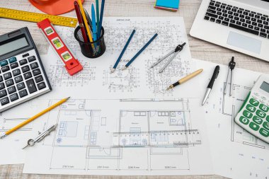 Top view of a drawing of the architects of a modern house with a sample of material on a creative table. Design concept